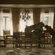 Will Forte pushing a t-rex skull onto a dining table in The Last Man On Earth.